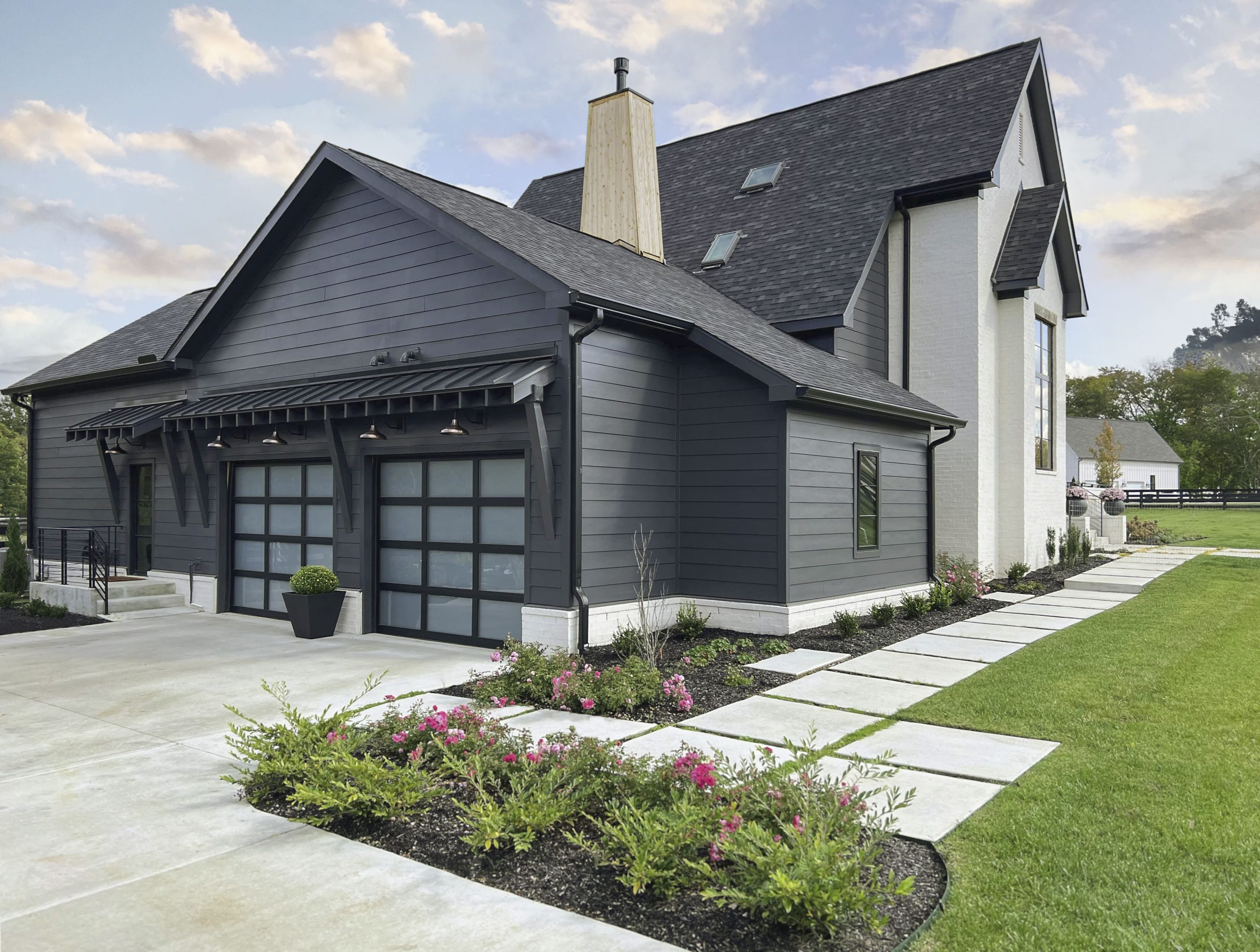 black modern home with clopay avante glass garage door