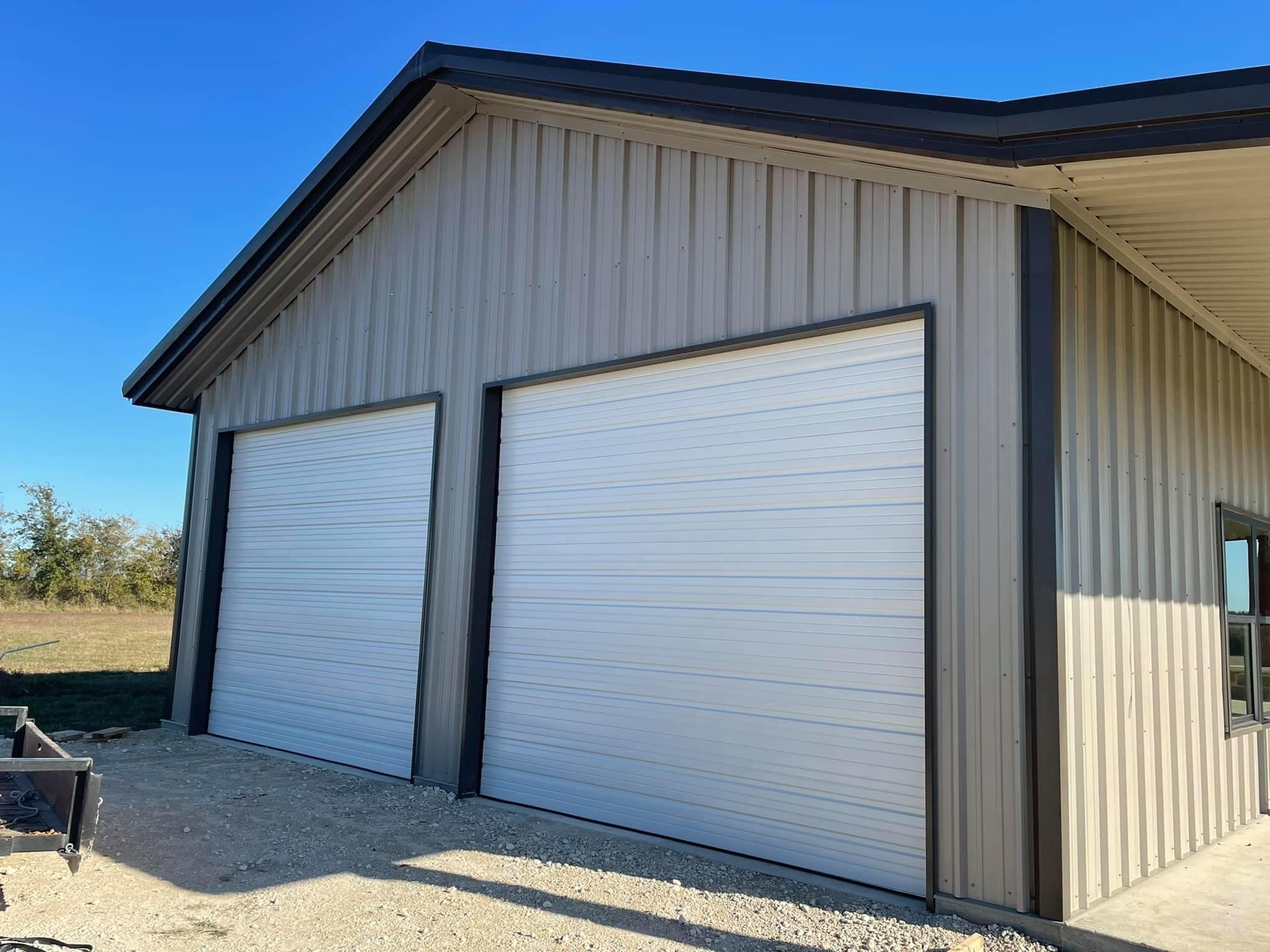 metal building with two white garage doors