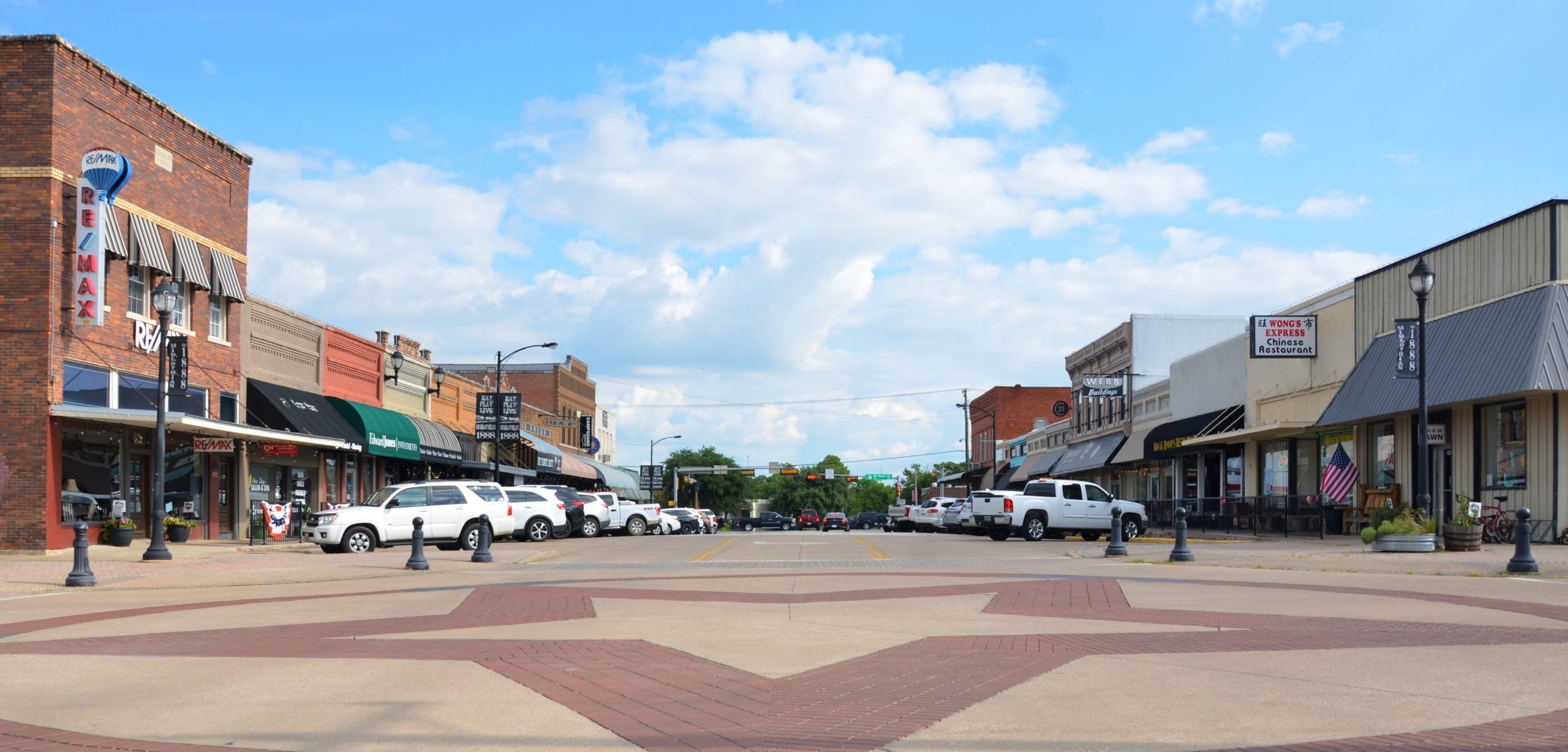 downtown Midlothian, Texas with buildings and parked cars