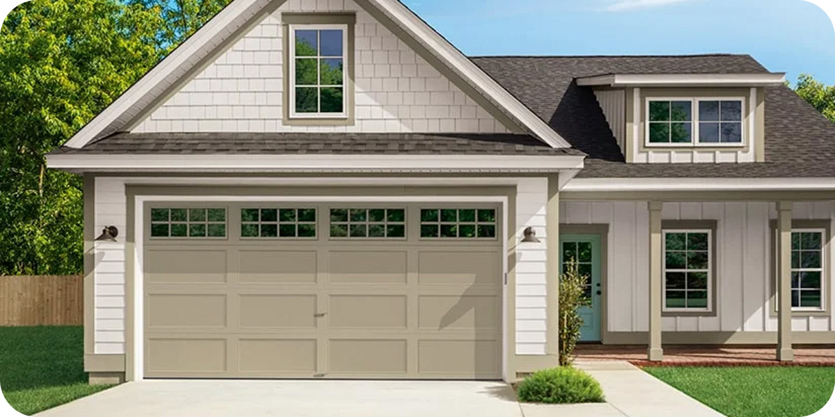 a white house with a tan garage door with four windows