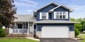 blue home with white garage door