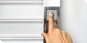 finger pressing garage door keypad button
